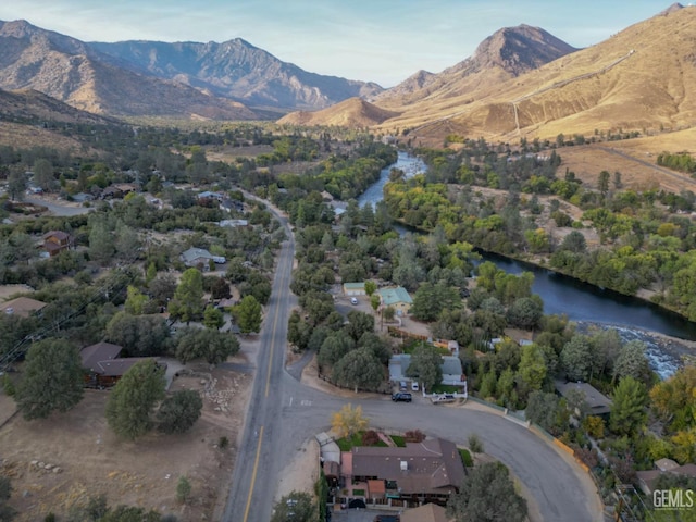 aerial view featuring a water and mountain view