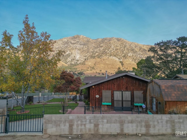 exterior space featuring a mountain view and a front lawn