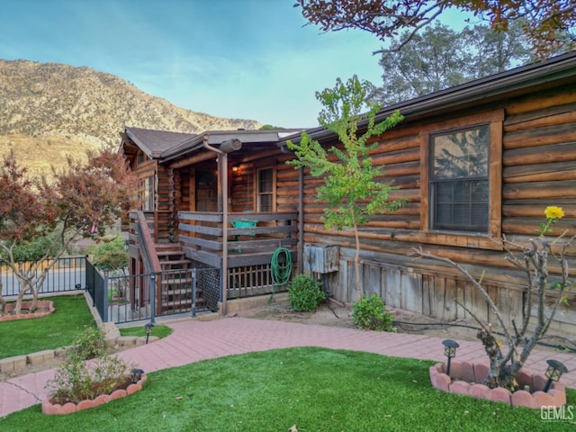 exterior space featuring a mountain view and a front yard