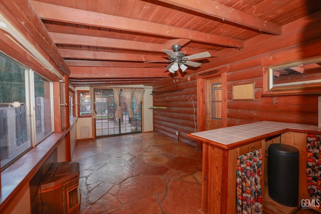 unfurnished sunroom featuring beamed ceiling, ceiling fan, and wooden ceiling