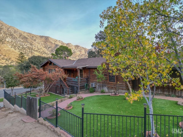 log home featuring a mountain view and a front yard