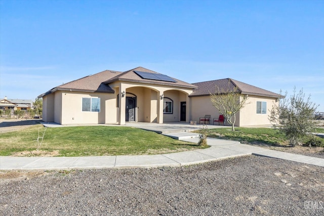 single story home with solar panels and a front yard