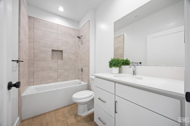 12914 Altair Ct, Bakersfield, CA 93314 - bathroom featuring tub / shower combination, vanity, recessed lighting, toilet, and wood finished floors