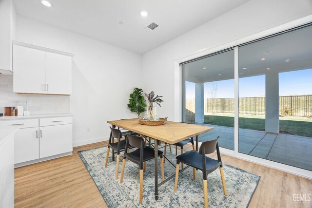 12914 Altair Ct, Bakersfield, CA 93314 - dining room featuring visible vents, baseboards, light wood finished floors, and recessed lighting