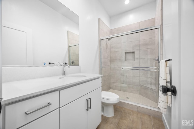12914 Altair Ct, Bakersfield, CA 93314 - bathroom featuring toilet, recessed lighting, vanity, wood finished floors, and a stall shower