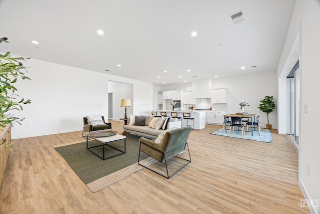 12914 Altair Ct, Bakersfield, CA 93314 - living room featuring light wood-style flooring, baseboards, visible vents, and recessed lighting