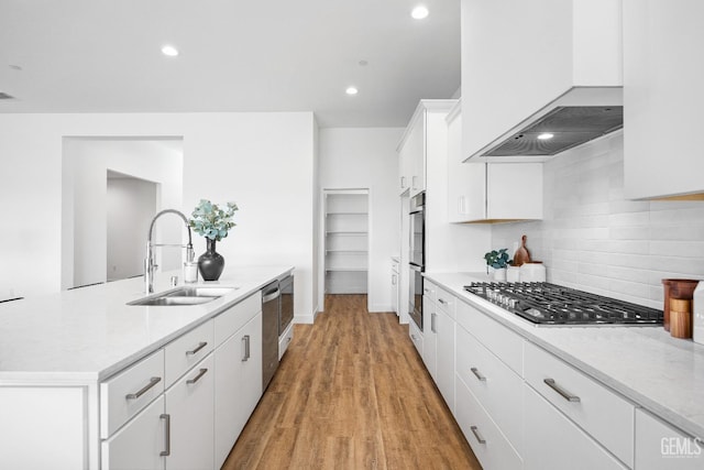 12914 Altair Ct, Bakersfield, CA 93314 - kitchen featuring white cabinets, a sink, appliances with stainless steel finishes, custom range hood, and decorative backsplash