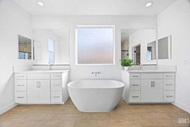 12914 Altair Ct, Bakersfield, CA 93314 - bathroom featuring a freestanding tub, a sink, and two vanities