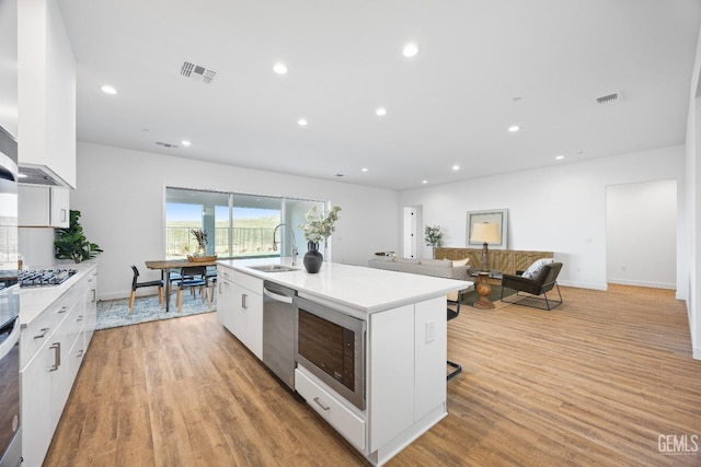 12914 Altair Ct, Bakersfield, CA 93314 - kitchen with visible vents, a sink, gas stovetop, white cabinetry, and built in microwave