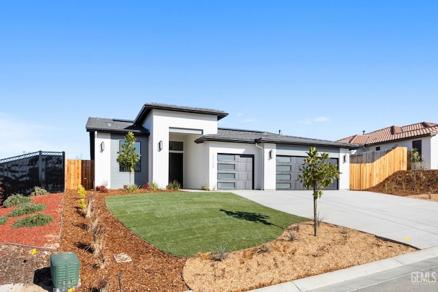12914 Altair Ct, Bakersfield, CA 93314 - prairie-style house with a garage, fence, concrete driveway, and stucco siding