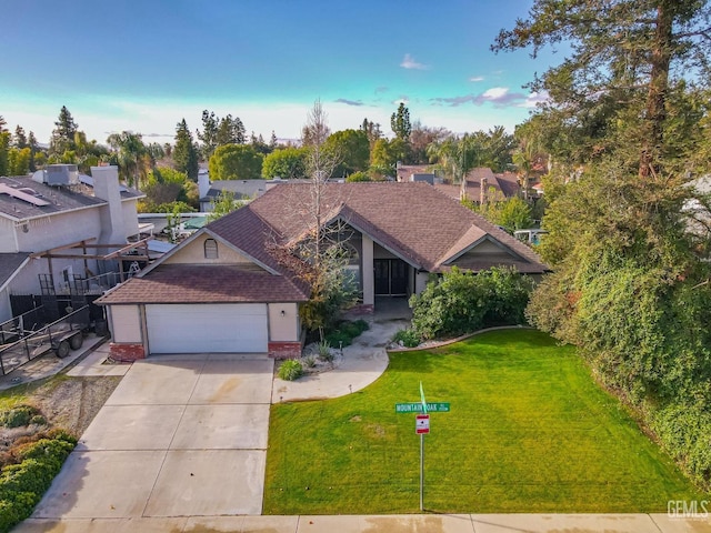 view of front of property featuring a garage and a front lawn