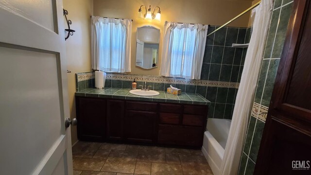 2617 4th St, Bakersfield, CA 93304 - full bath featuring vanity, shower / bath combo with shower curtain, and tile patterned floors