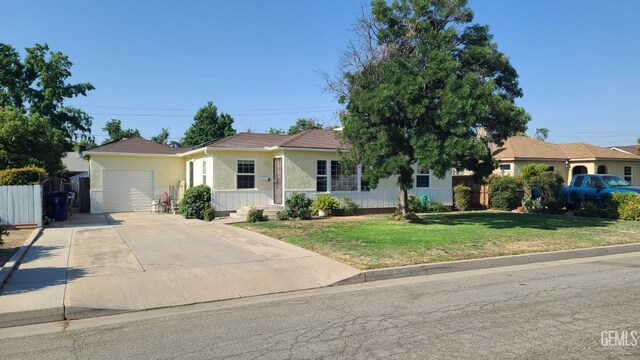 2617 4th St, Bakersfield, CA 93304 - ranch-style home with an attached garage, concrete driveway, and stucco siding
