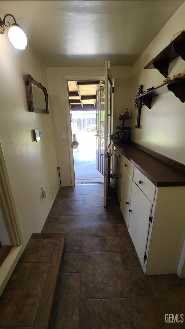 2617 4th St, Bakersfield, CA 93304 - hallway with dark stone finish flooring and baseboards