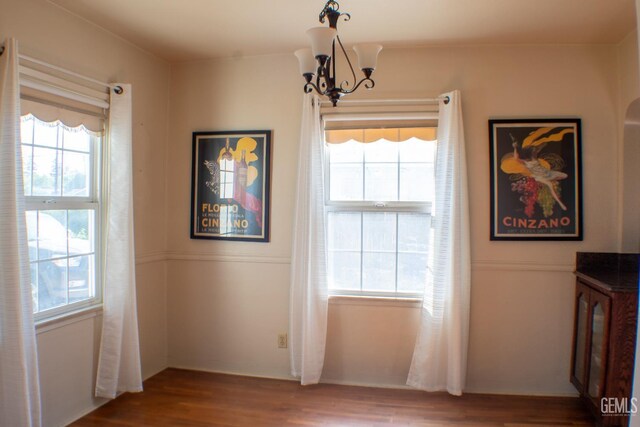 2617 4th St, Bakersfield, CA 93304 - unfurnished dining area with a chandelier and wood finished floors