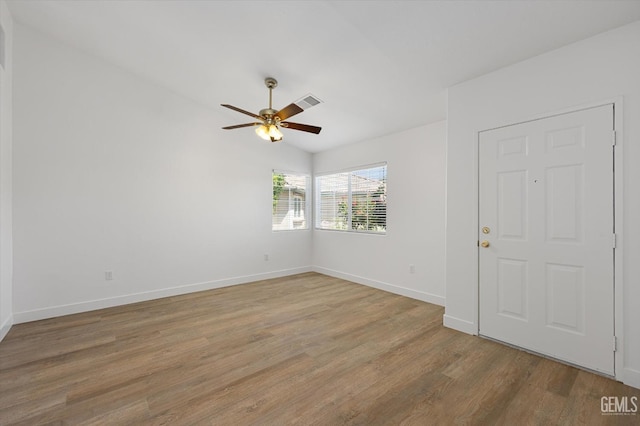 spare room with hardwood / wood-style flooring, ceiling fan, and lofted ceiling