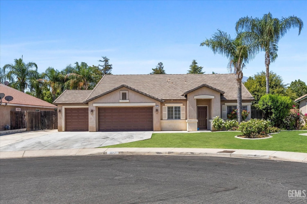 view of front of home with a garage and a front lawn