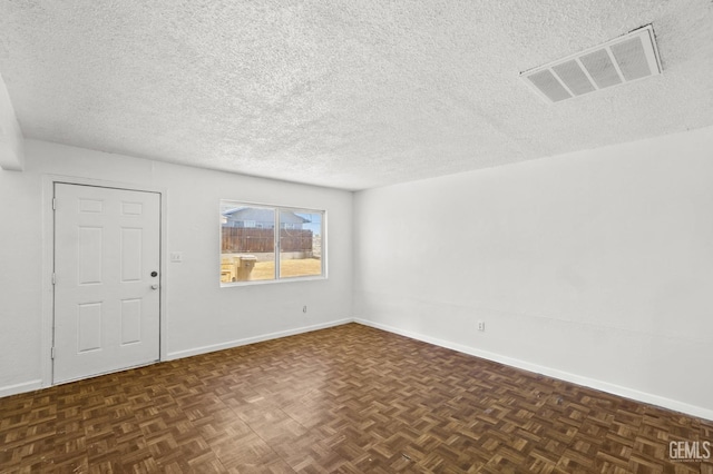 unfurnished room featuring dark parquet flooring