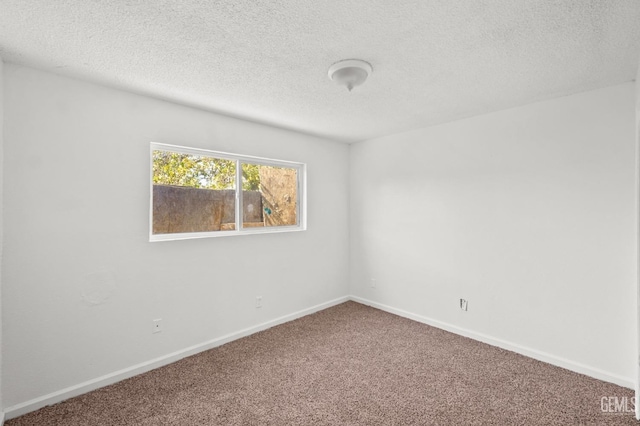 carpeted spare room with a textured ceiling