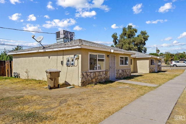 view of side of property with central AC unit