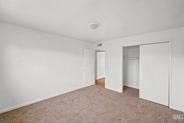 unfurnished bedroom with carpet floors and a closet