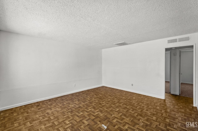 unfurnished room featuring dark parquet floors and a textured ceiling