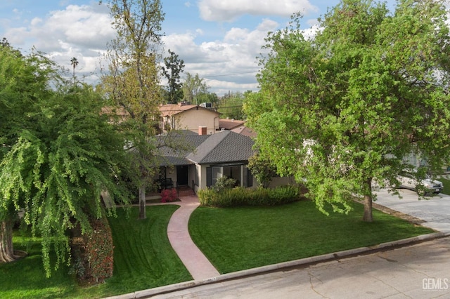3025 19th St, Bakersfield, CA 93301 - view of front facade with driveway, a shingled roof, and a front lawn