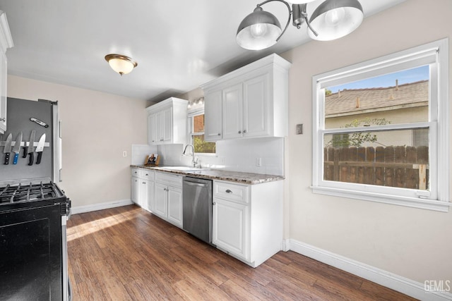 3025 19th St, Bakersfield, CA 93301 - kitchen featuring stainless steel dishwasher, white cabinetry, a sink, gas range, and backsplash