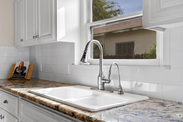 3025 19th St, Bakersfield, CA 93301 - room details with white cabinetry, light countertops, a sink, and tasteful backsplash