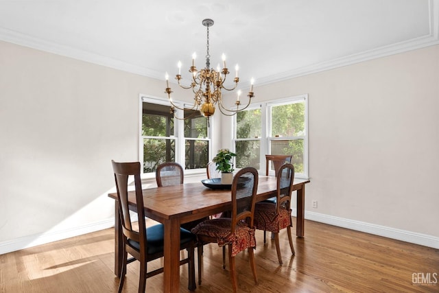 3025 19th St, Bakersfield, CA 93301 - dining area featuring baseboards, wood finished floors, ornamental molding, and an inviting chandelier