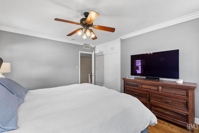 3025 19th St, Bakersfield, CA 93301 - bedroom with wood finished floors, ornamental molding, ceiling fan, and visible vents