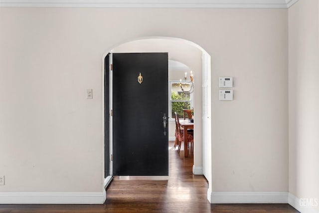 3025 19th St, Bakersfield, CA 93301 - corridor with an inviting chandelier, arched walkways, baseboards, and wood finished floors