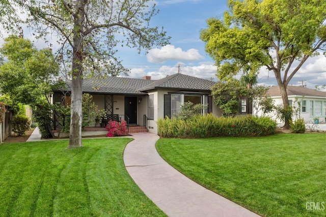 3025 19th St, Bakersfield, CA 93301 - ranch-style house with a front yard, stucco siding, and a chimney