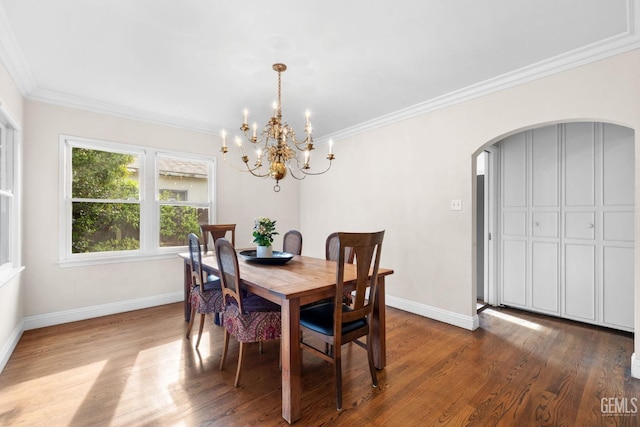 3025 19th St, Bakersfield, CA 93301 - dining room featuring arched walkways, dark wood-style floors, a chandelier, and crown molding