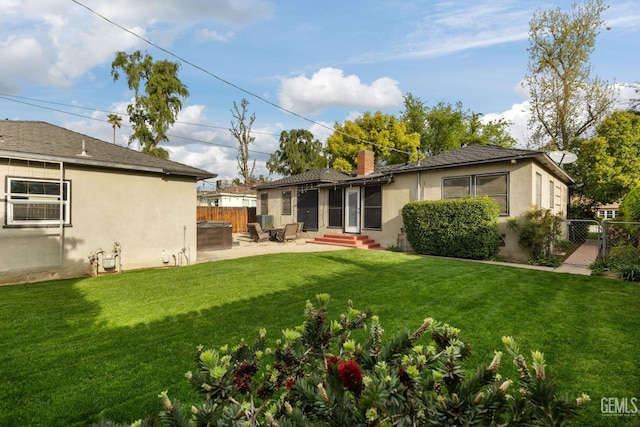 3025 19th St, Bakersfield, CA 93301 - back of property featuring fence, stucco siding, entry steps, and a lawn
