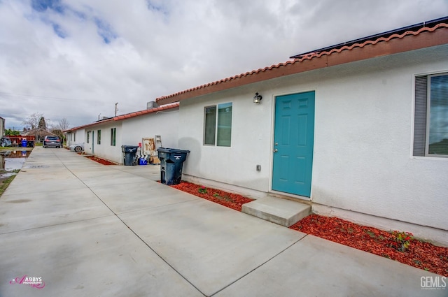exterior space with a patio and stucco siding