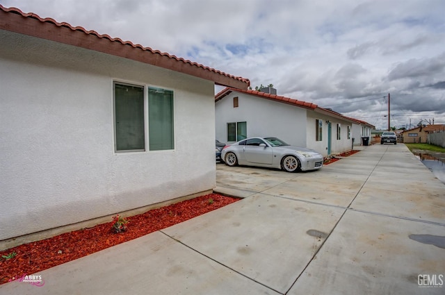 view of side of home with stucco siding
