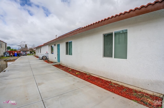 view of side of home with stucco siding