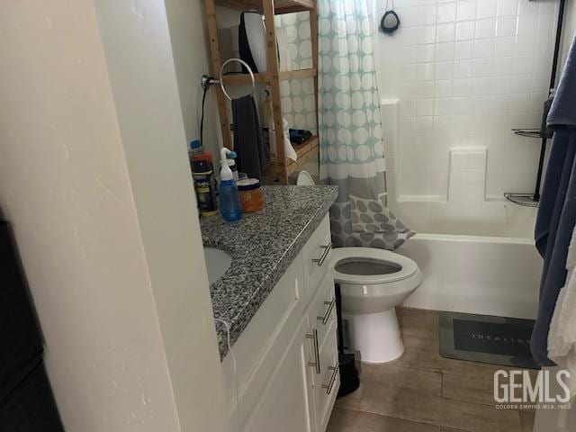 bathroom with toilet, shower / bath combo, and vanity
