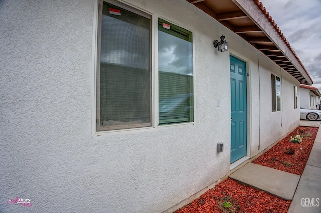 property entrance featuring stucco siding