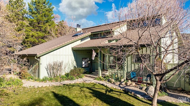 rear view of house featuring a lawn