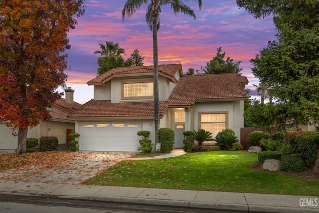 view of front facade featuring a yard and a garage