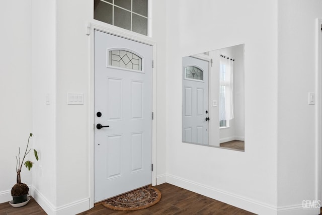 foyer entrance with dark hardwood / wood-style floors