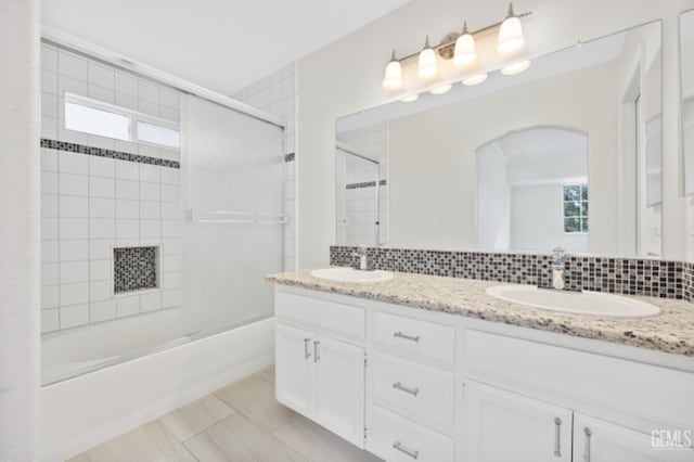 bathroom with vanity, backsplash, tile patterned floors, and bath / shower combo with glass door