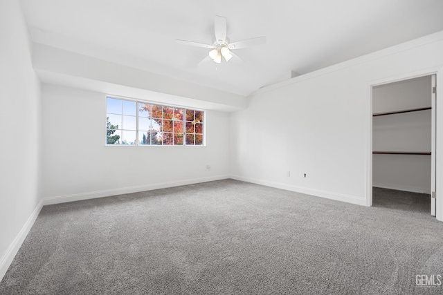 unfurnished bedroom featuring carpet flooring, ceiling fan, lofted ceiling, and a closet