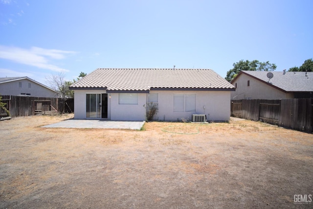 back of property with a patio, a tile roof, a fenced backyard, and stucco siding