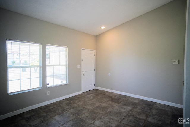 foyer entrance with baseboards and recessed lighting