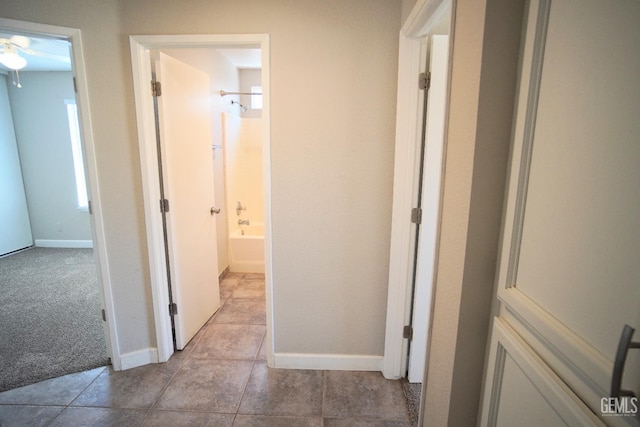 corridor with light colored carpet and baseboards