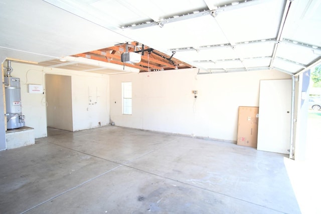 garage featuring water heater and a garage door opener