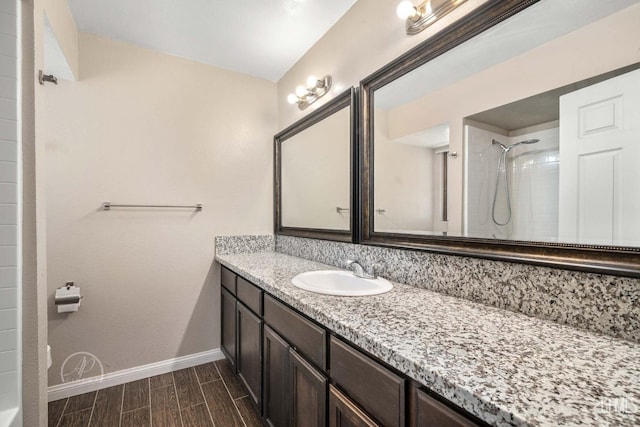 bathroom with vanity and a tile shower